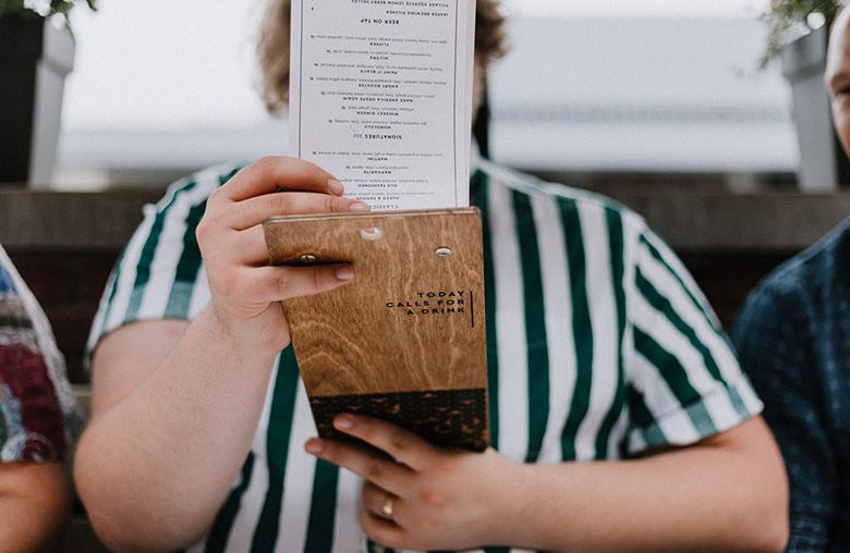 Satisfied customer holding restaurant menu